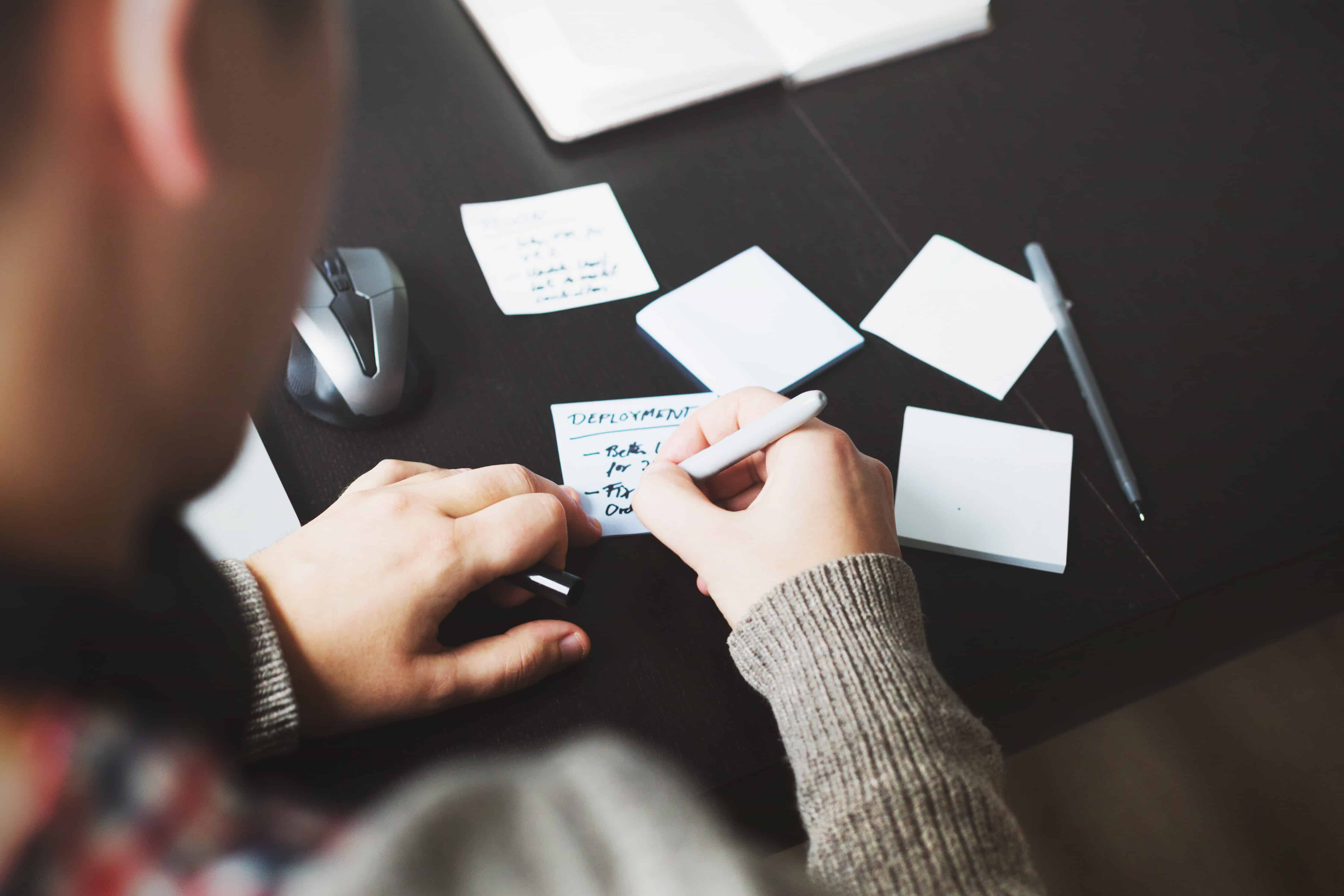 man writing notes