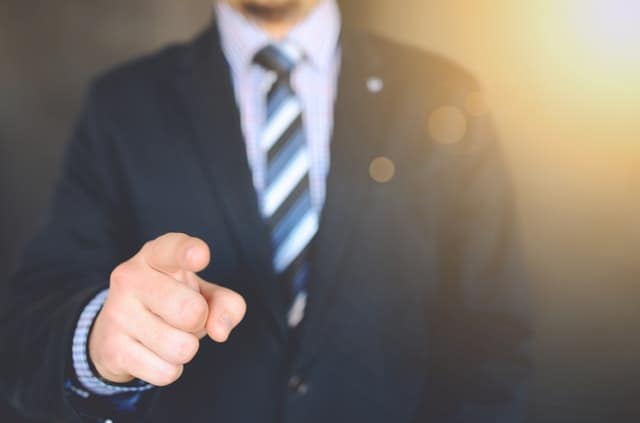 man in a suit pointing